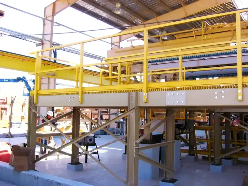 Heavy-duty FRP grating access platform with handrail in a chemical processing facility