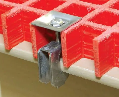 FRP grating G-clip with plate, bolt and U-clamp securing a molded grating panel to its support