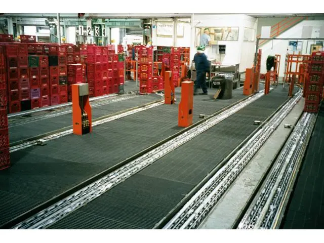 FRP molded grating flooring under a conveyor line in a food processing facility