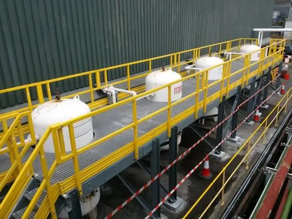 ZeAllgrate FRP grating access platform with guardrails installed above process tanks in a pharmaceutical facility